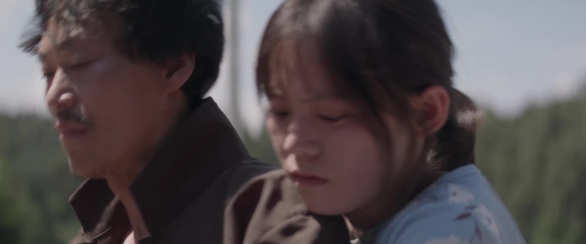 A woman frantically grabs at something in front of a man