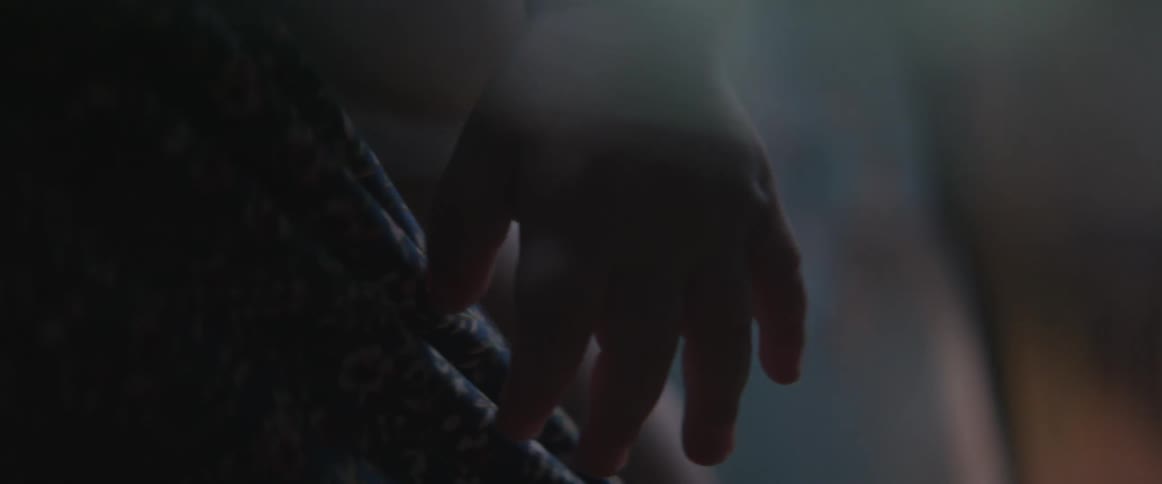 An infant's arm hangs in the air