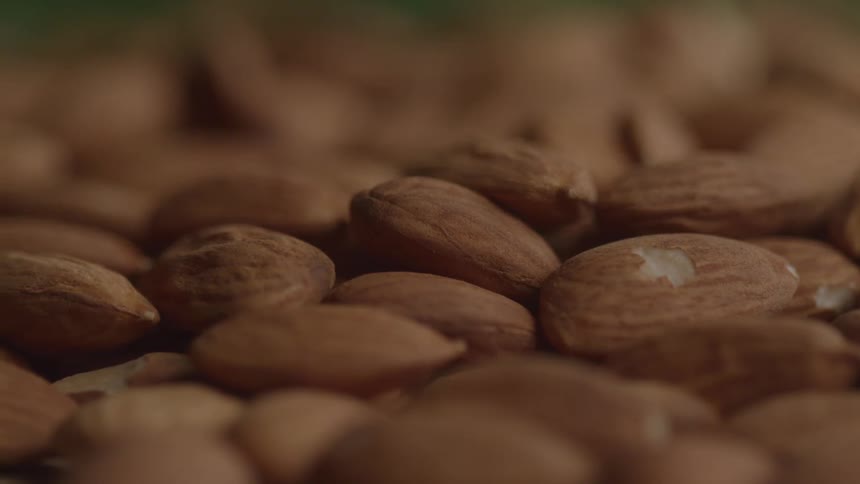 Almonds arranged on a surface with a blurred background