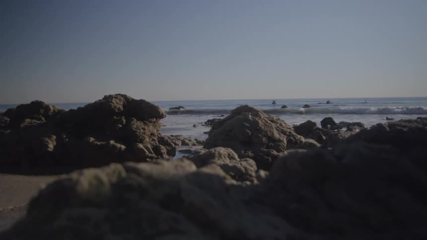 Rocks on the beach sand with the biggest background