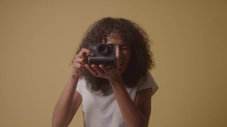Woman taking pictures with a vintage camera