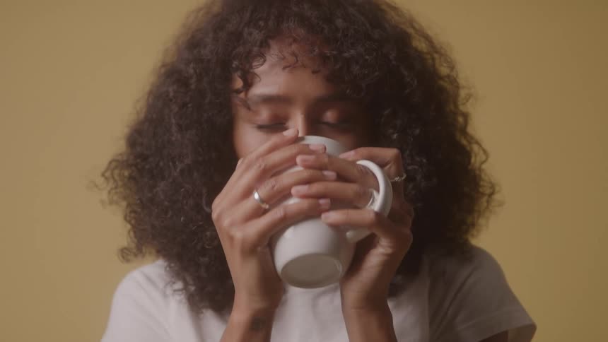 Woman drinking from a white mug