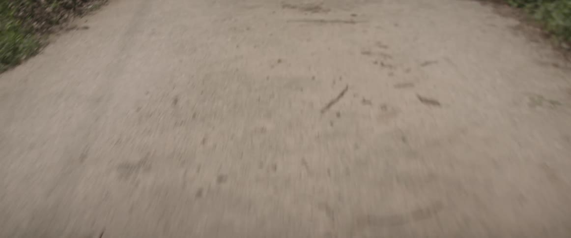 A concrete road littered with dirt