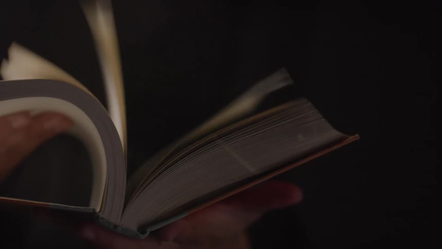 A person is flipping the pages of the book