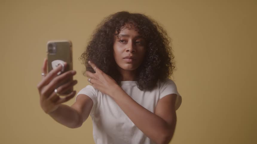 The woman is taking selfies with her phone