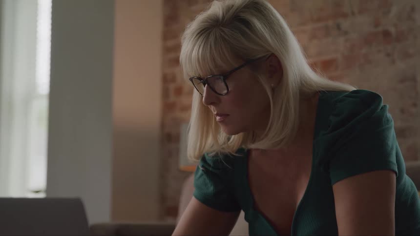 Woman wearing glasses looking intently at something in front of her