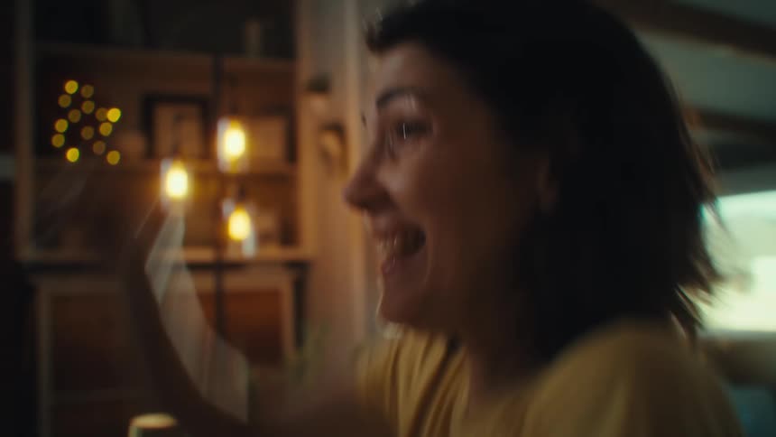 Happy woman playing video game holding a controller