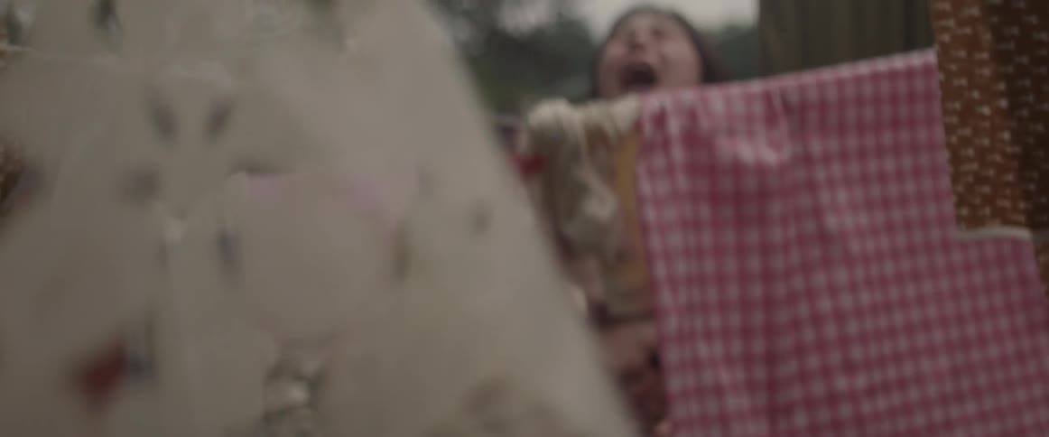 A woman is fighting with a man in a yard