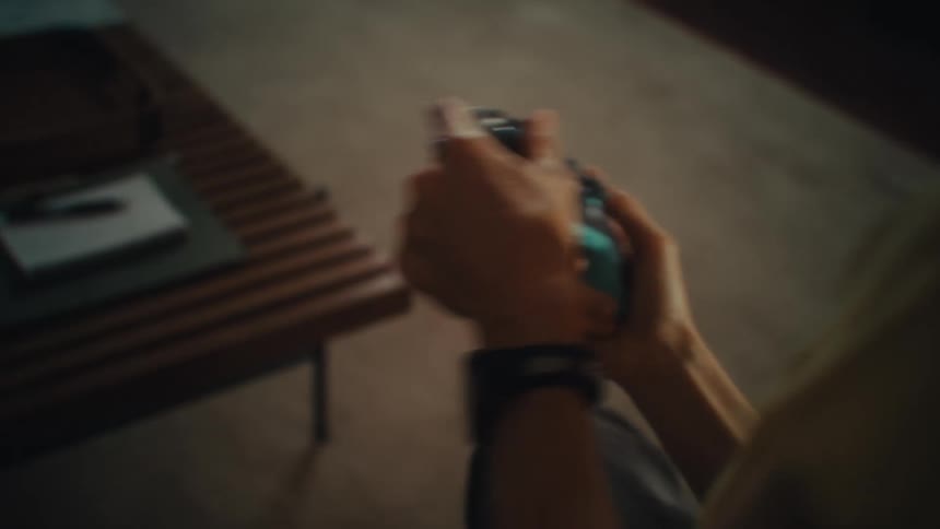 Pair of hands of a woman judging the video game holding a wireless controller