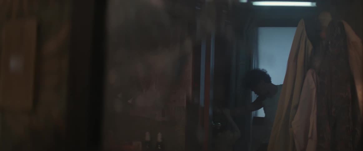 A man is fighting with someone in a dark hall