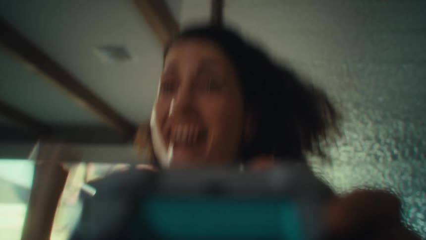 Woman having fun holding and playing a video game controller