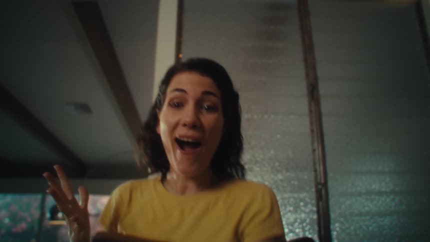 Woman celebrating happily while watching and holding a smartphone