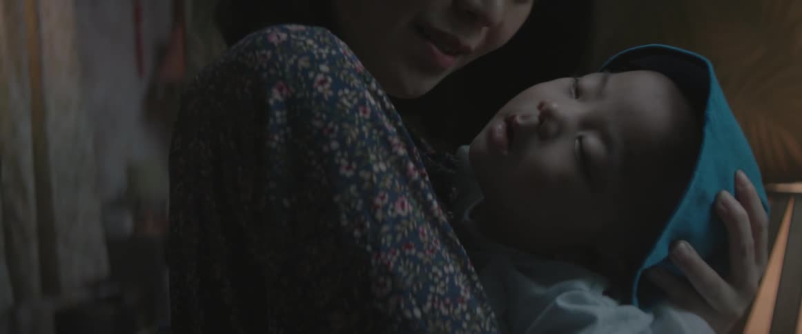 An asian woman holds a baby girl in her arms