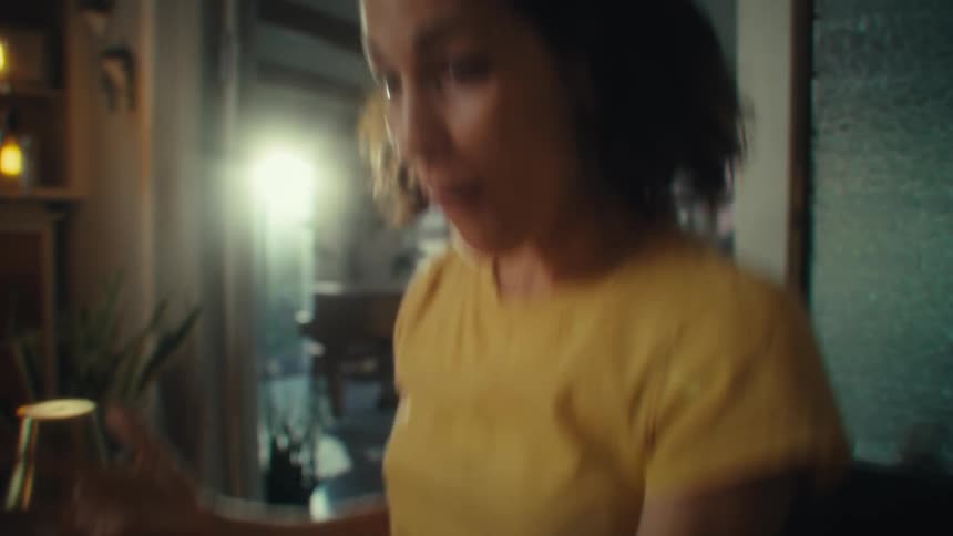 A woman is very excited while looking at her phone