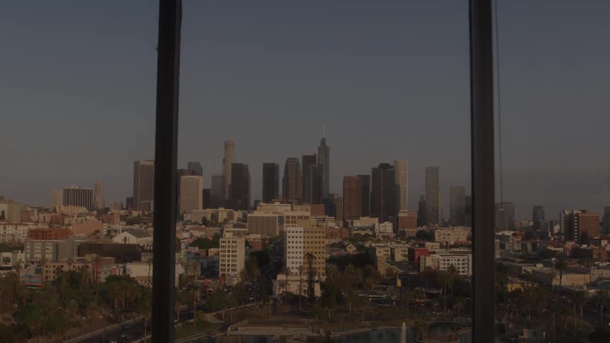 City view with tall buildings in the background framed by a window