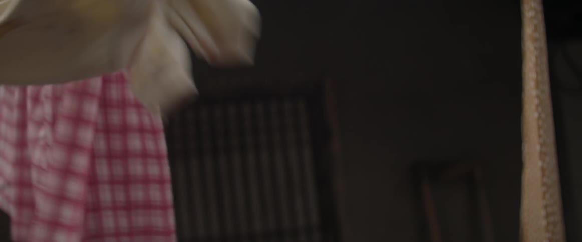 A shirt is being pulled off a laundry line