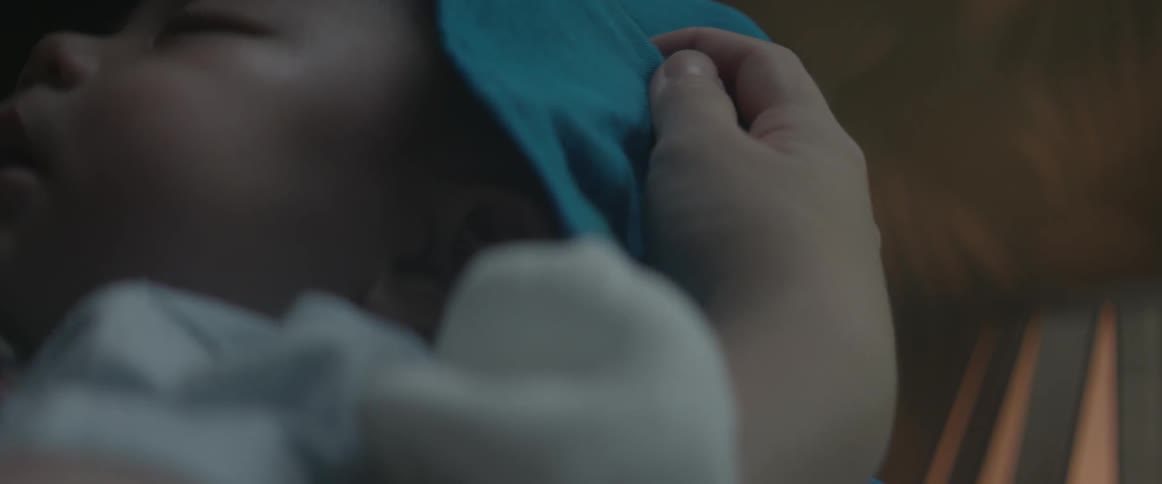 A baby is being cradled in someone's arms