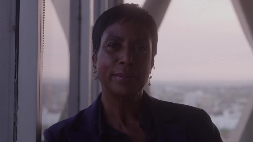 An older woman with short hair and a determined look