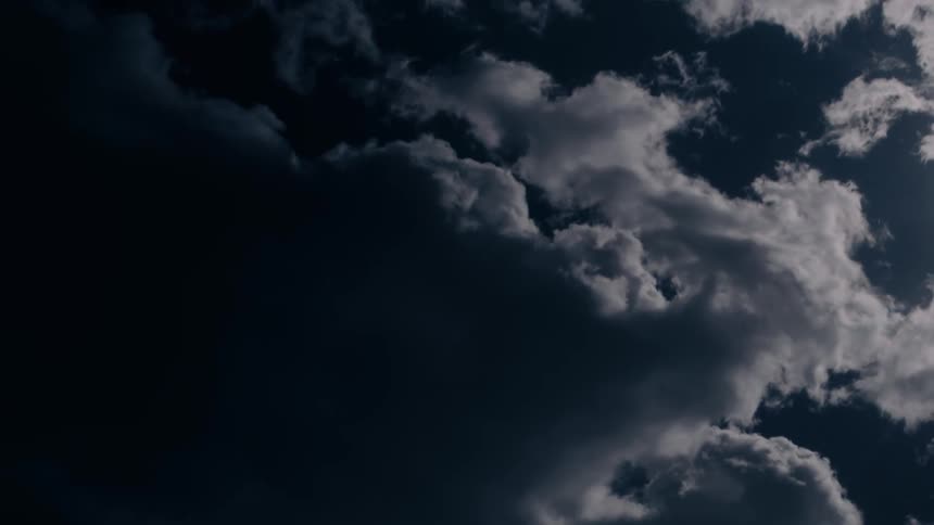 Fluffy clouds pass by overhead