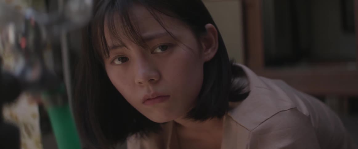 A woman looks to the side worried