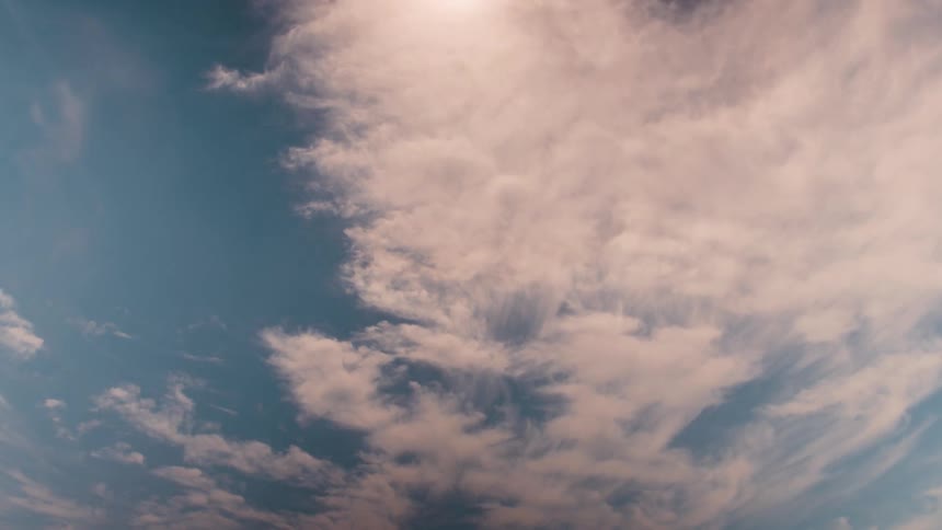 Fluffy clouds move across the sky