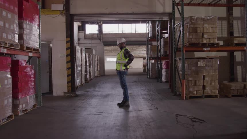 A man at work stretching his back because he is in pain