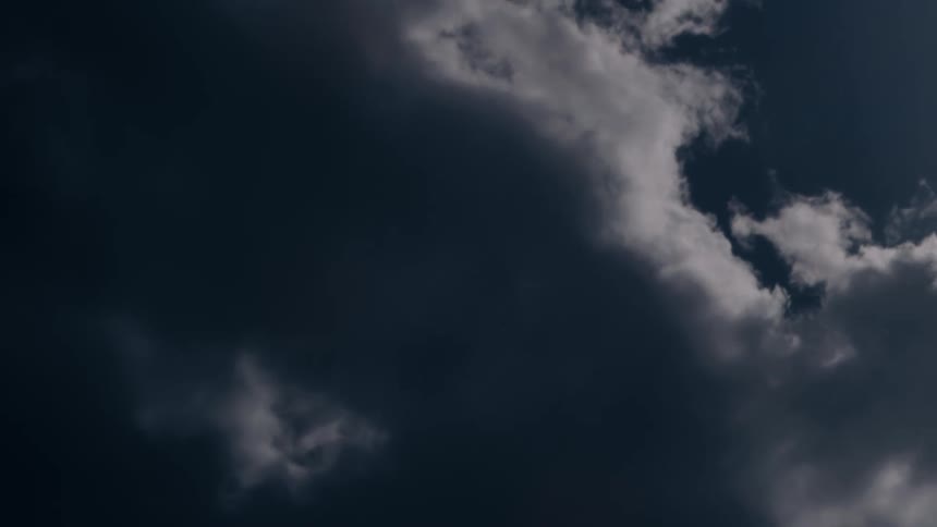 Fluffy clouds move across the sky