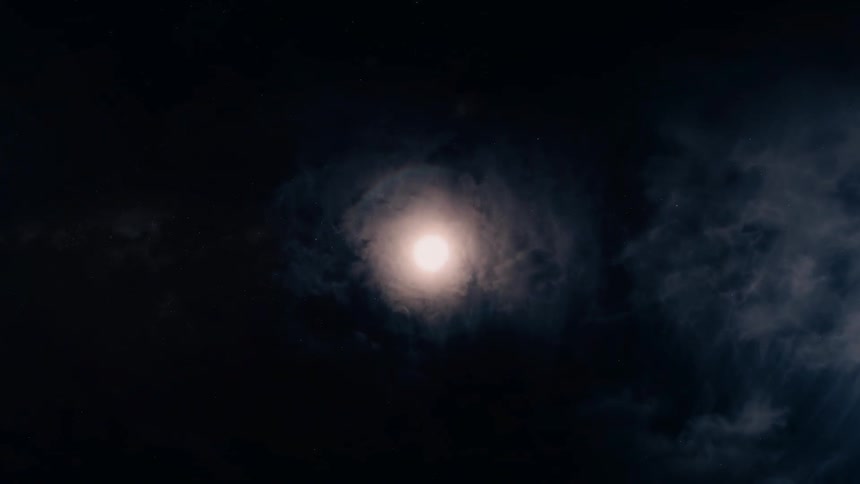 Clouds pass by over the moon