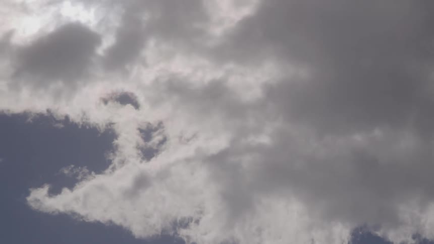 Fluffy clouds move across the sky
