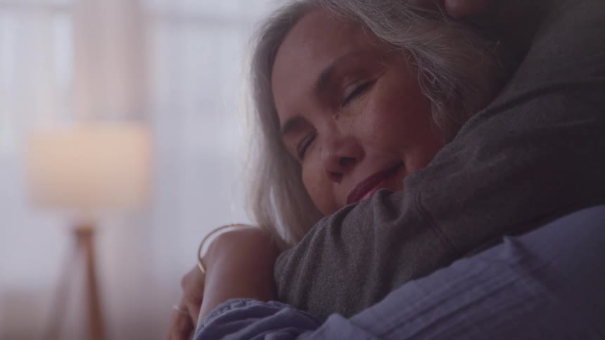 Portrait of a woman embraced by a man affectionately