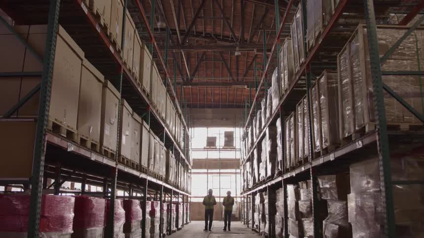 Two men walking in a warehouse