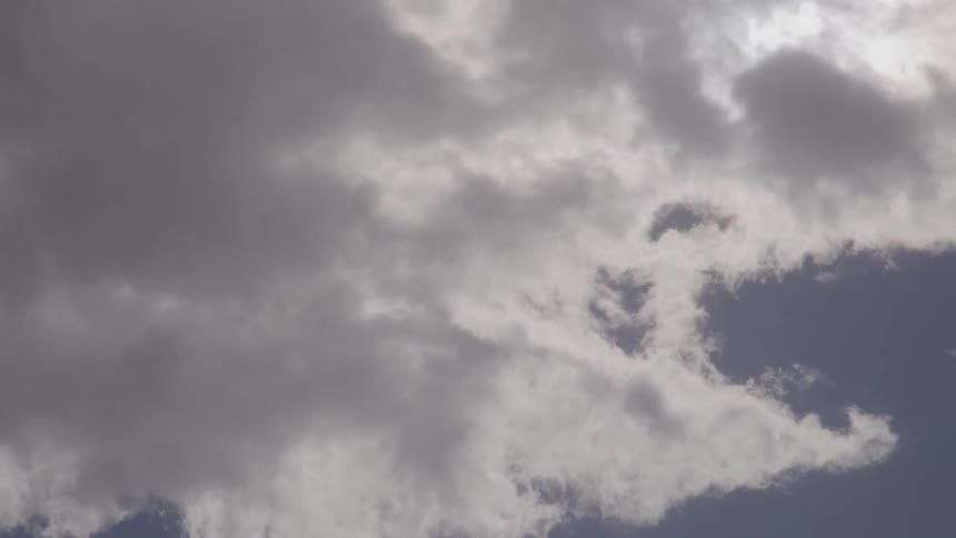 Clouds pass over the sunny sky