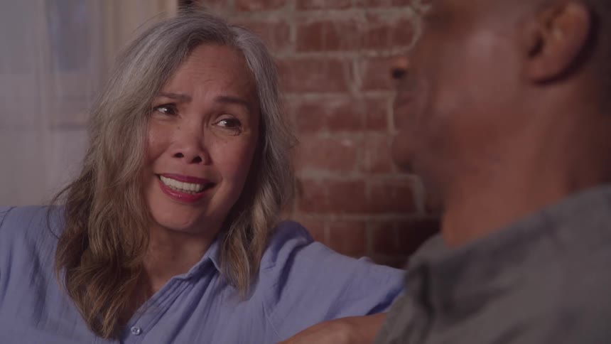 Woman and a man sitting and talking smiling
