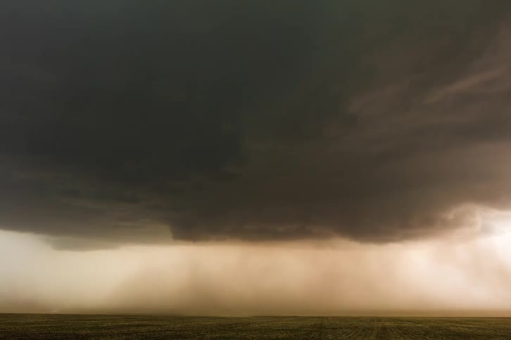 Dark storm cloud over dusty plains