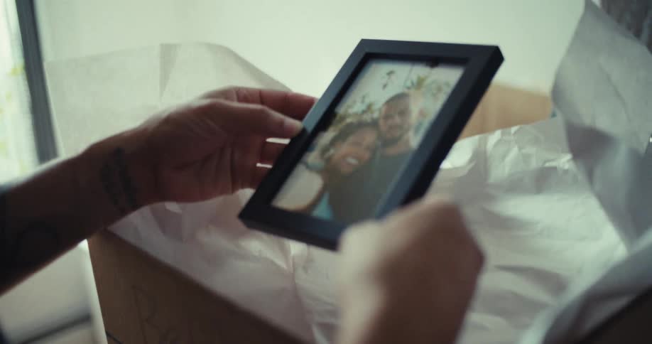 Pair of hands viewing a photograph in a frame
