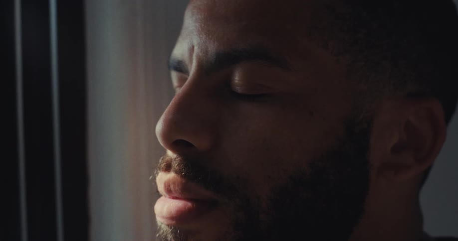 Close up portrait of a young black man in a room during daytime