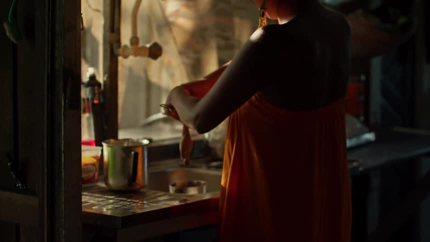 Woman washing utensils in the kitchen sink