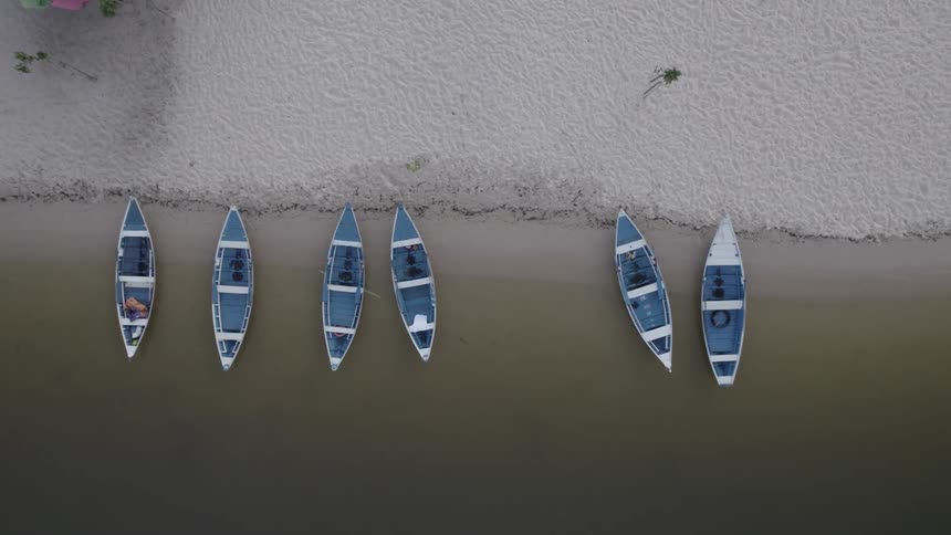 Several row boats docked at the beach