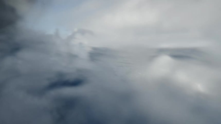 Ocean surface with part of a boat visible on the left