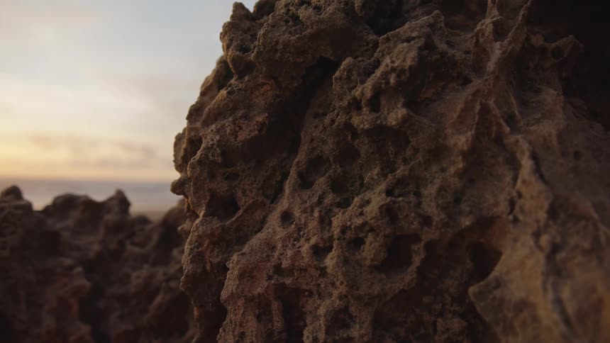 Closeup of volcanic rock with a rough surface likely formed from cooled lava