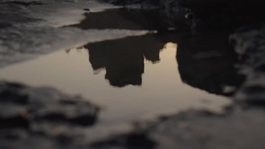 Puddle of water between rocks on the beach