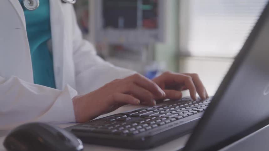 A person types at a computer