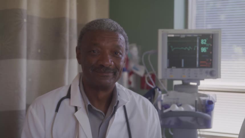 Doctor in white coat in a hospital room