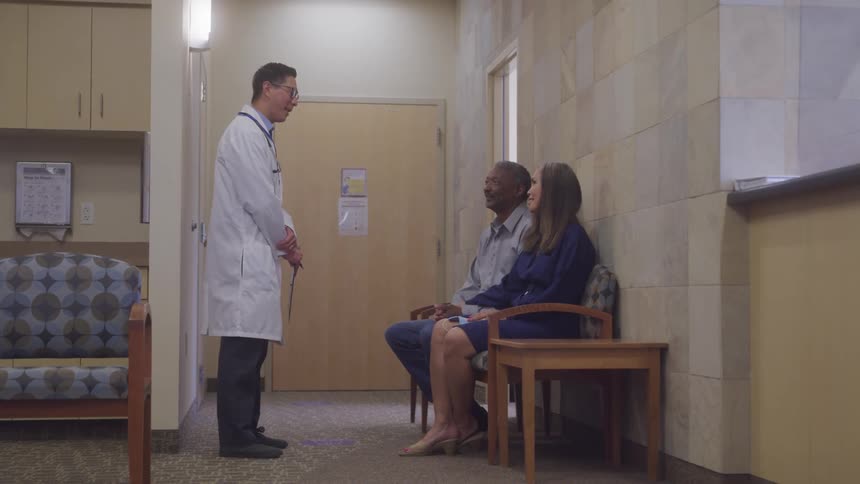 Doctor updating family members with good news in a hospital waiting room