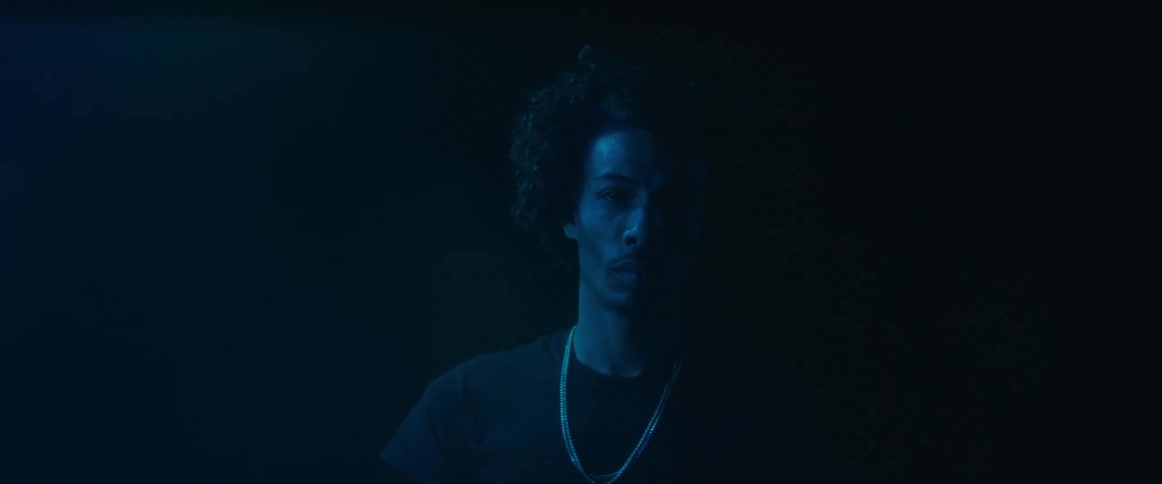 Man in a dark space with blue light illumination
