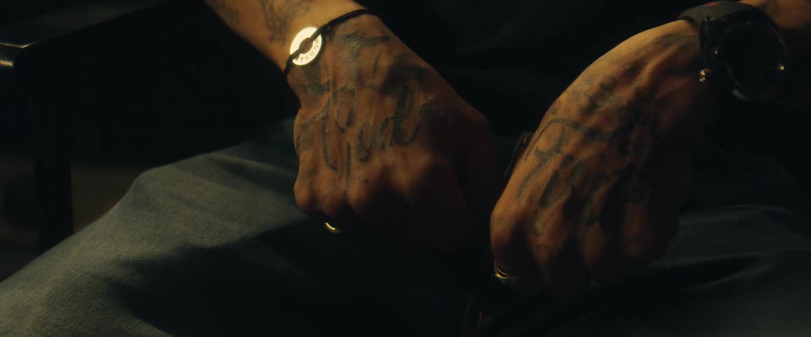 A man has tattoos on his hands