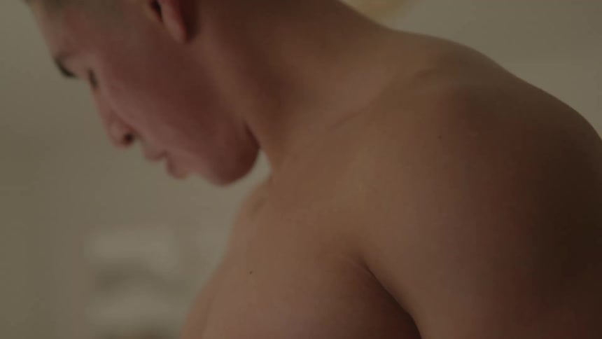 Close up of a young man lifting gym weights during a fitness session indoors during daytime