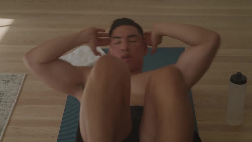 A man is working out on a yoga mat