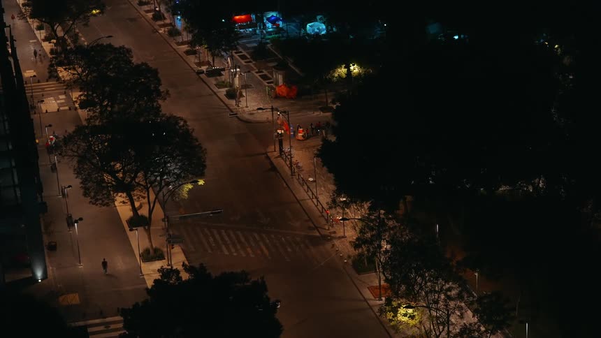 Aerial view of a street lit at night with light traffic and a construction area