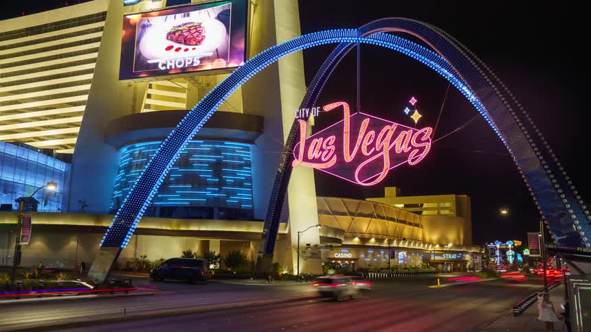 Las vegas street busy with cars and pedestrians at night